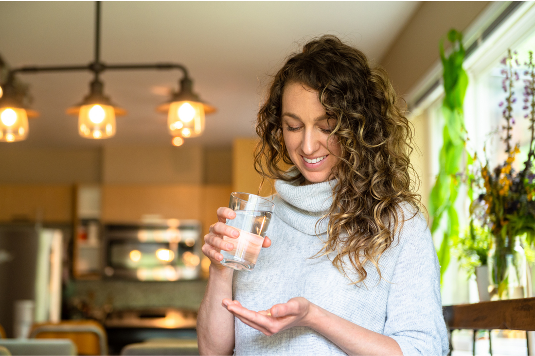 Woman taking a supplement to manage her period symptoms