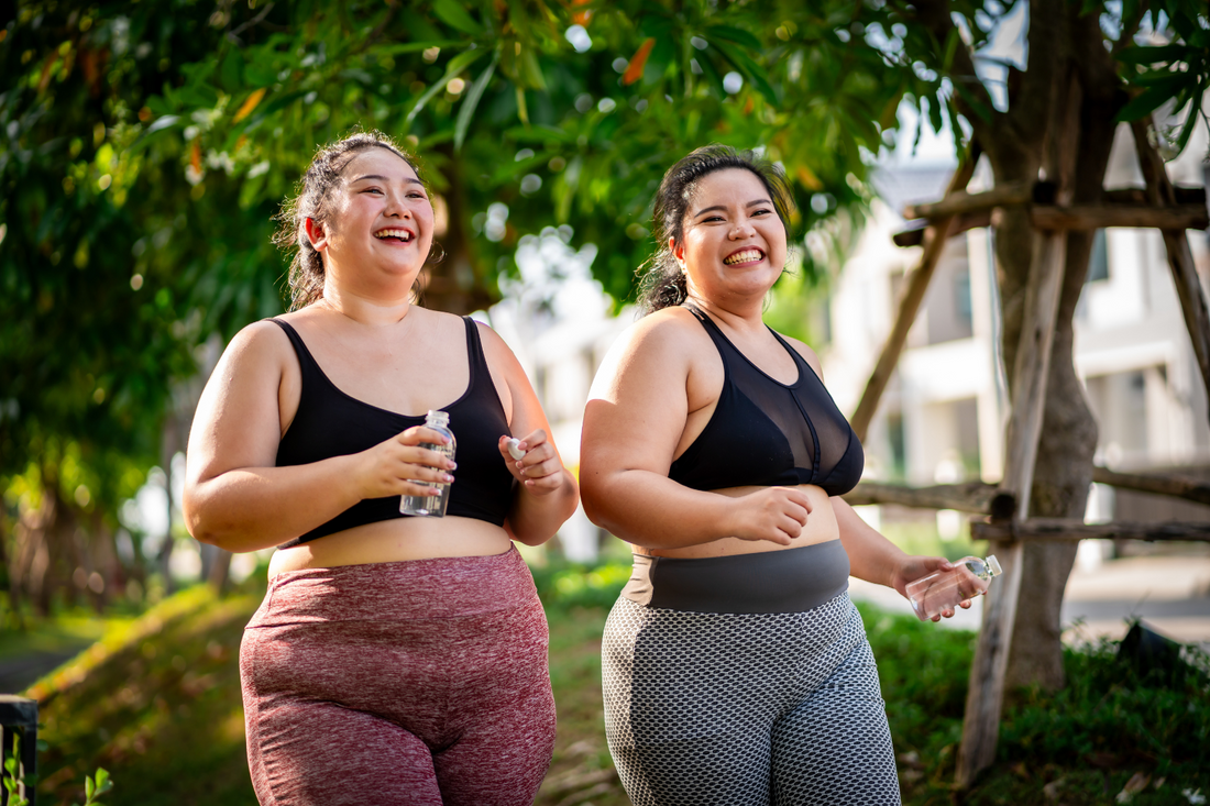 Two women exercising, which is known to help with cramps