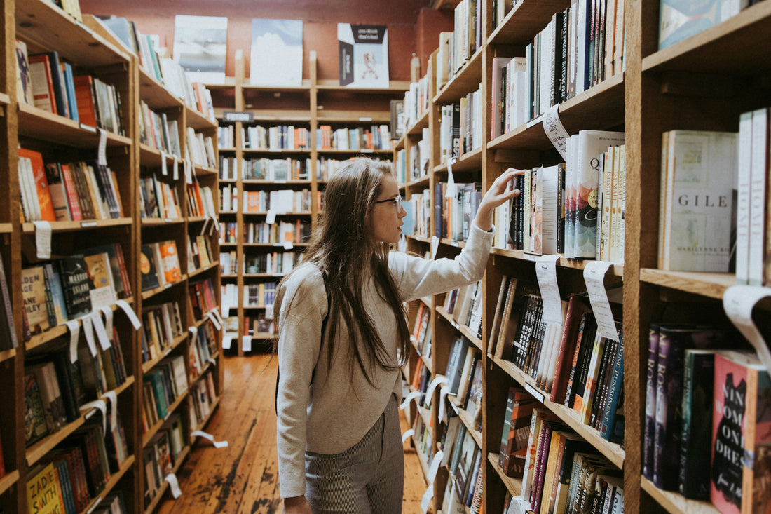 Young woman browsing books at the library